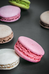 Sweet and colourful french macaroons on a black background
