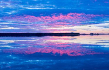 Naklejka na ściany i meble Scenic view of a midnight lake in sunset