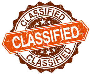 classified orange round grunge stamp on white