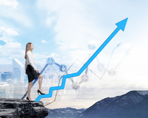 Full length beautiful woman in formal clothes on the rock is going up along the growing arrow....
