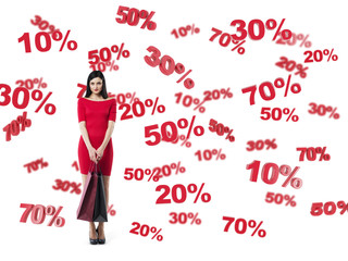 Happy brunette in a red dress with the shopping bags. Discount and sale symbols: 10% 20% 30% 50% 70%. Isolated.