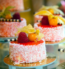 cakes decorated with berries on a show-window of shop