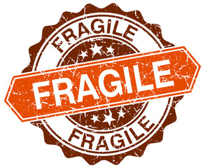 Obraz premium fragile orange round grunge stamp on white
