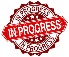 in progress red round grunge stamp on white