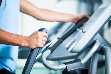 Fototapeta na wymiar Man exercising on treadmill in gym