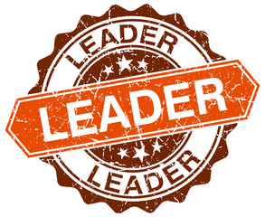 Obraz premium leader orange round grunge stamp on white