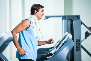 Happy man exercising in gym