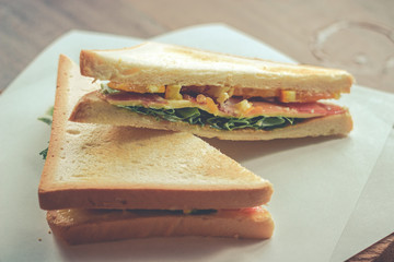 sandwich with bacon and vegetables in vintage style