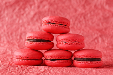 Red macarons on red paper background