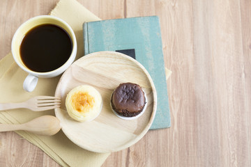 Hokkaido chocolate cheesecake with coffee cup with wooden backgr