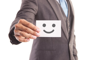 Businessman hand showing someone his business card with Smiley face