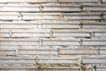 crude brick and sand  background texture with light from corner