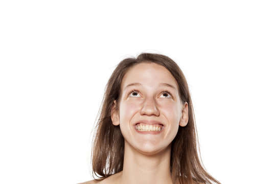 happy young woman without make-up looking up