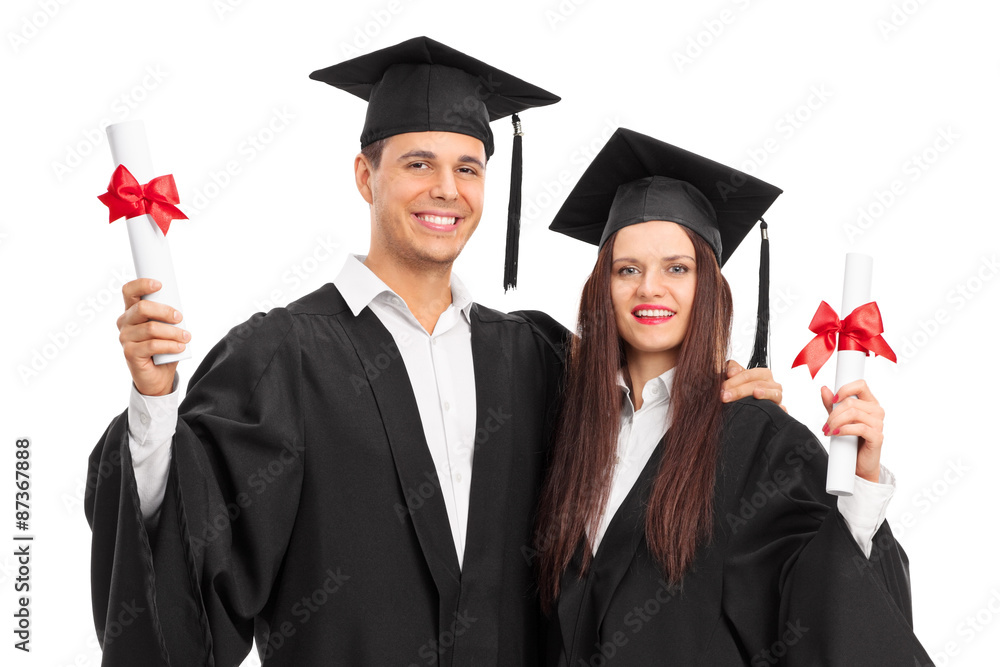 Wall mural Young couple posing with their diplomas