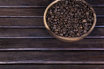 coffee beans on a dark wooden background grunge, coffee in the wooden plate on a wooden table