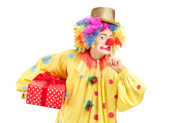 Young male clown holding a present wrapped in a red paper and ho