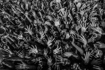 sculpture of people raising their hands to the sky