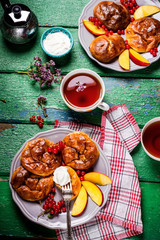 Fritters and tew on wooden table.