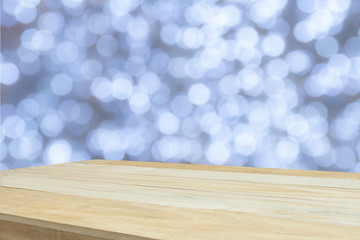wood table in front of white bright bokeh lights