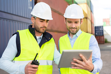 Two young attractives dockers working on the dock