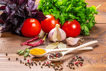 Raw vegetables, basil and spices on the wood table