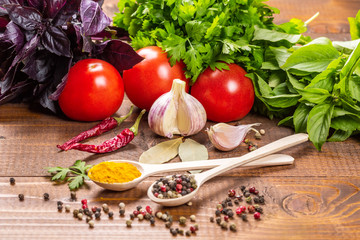 Raw vegetables, basil and spices on the wood table
