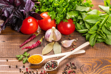 Raw vegetables, basil and spices on the wood table