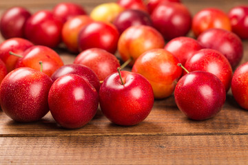 Sweet plums on wooden background