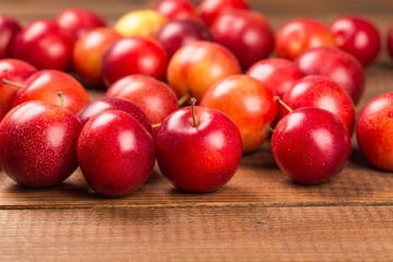 Sweet plums on wooden background