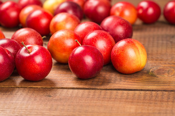 Sweet plums on wooden background