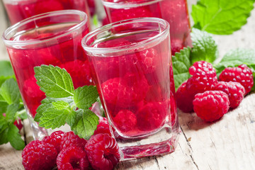 Red refreshing cocktail with raspberry and mint, selective focus