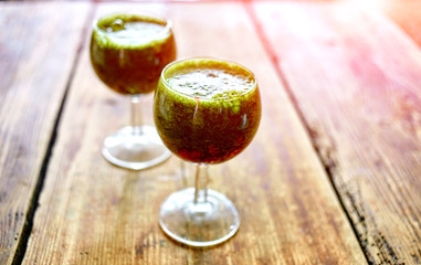Green vegetable juice in wine glass