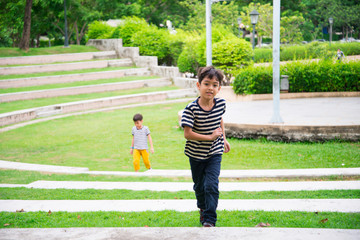 Little boy walking on the step in the park
