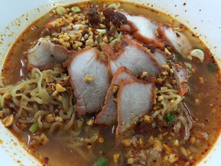 Noodle with pork and soup in Thai spicy style called Tom-Yum