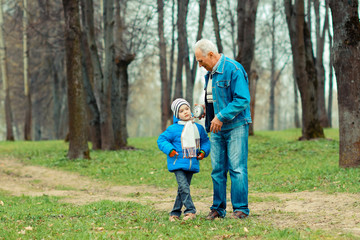 Grandfather showing grandson vintage watches. The grandfather tells his grandson about time.