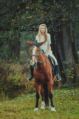 Romantic girl in a white horse. beautiful girl and a horse