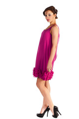 Young and sexy woman model in pink dress posing