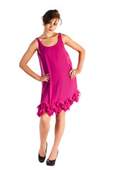 Young and sexy woman model in pink dress posing