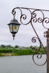 Fototapeta na wymiar vintage lamp on an iron gate
