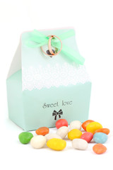 close-up isolated wedding bonbonniere with candies and wedding rings
