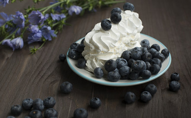 Blueberries and cream with flowers