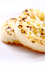 Crumpets.
Crumpets on a plate isolated.