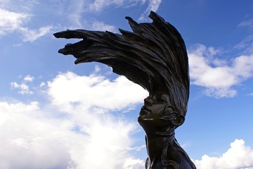 Sculpture woman's head against the sky