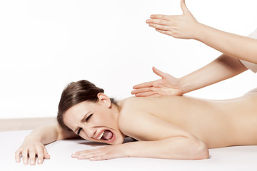 Fototapeta na wymiar young woman in pain at bad Massage treatment