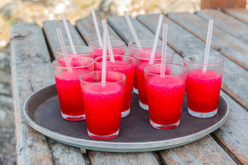 Strawberry juices in  tray on Wooden pathway