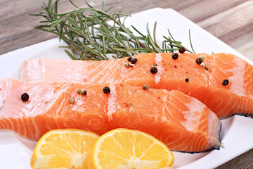 Fresh salmon fillet with rosemary and lemon slices