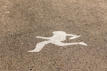 White Running Sign on the road