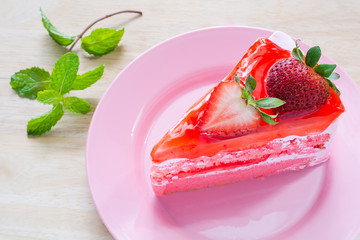 Pink strawberry cake delicious with green mint on pink dish