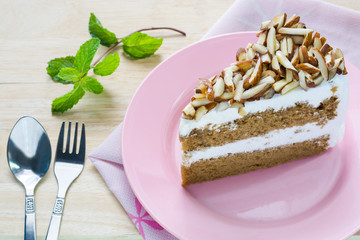 Coffee almond cake delicious with green mint  on dish on table.