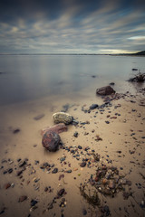  Sunrise over the sea. Beautiful long exposure landscape of rocky shore